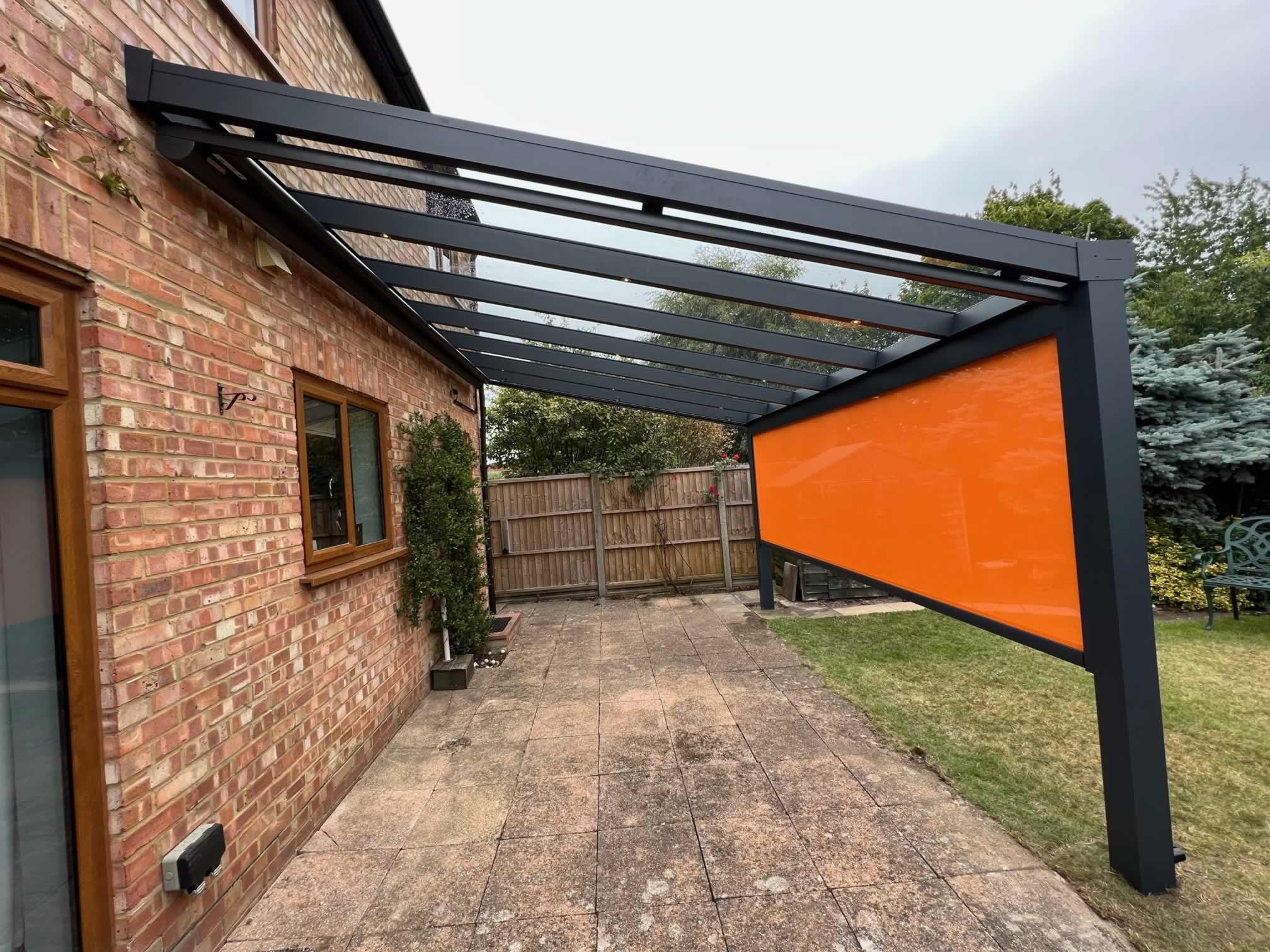 Glass Veranda With Orange Vertical Sun Screen On Front